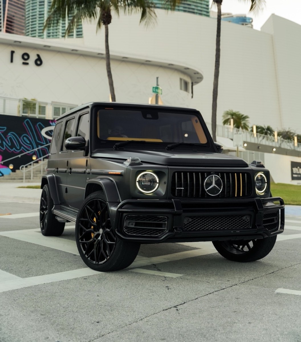 Dark Mercedes-AMG G63 photographed beside Miami Art Deco architecture